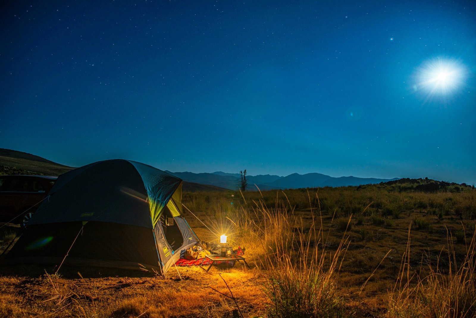 a tent in the middle of a field at night